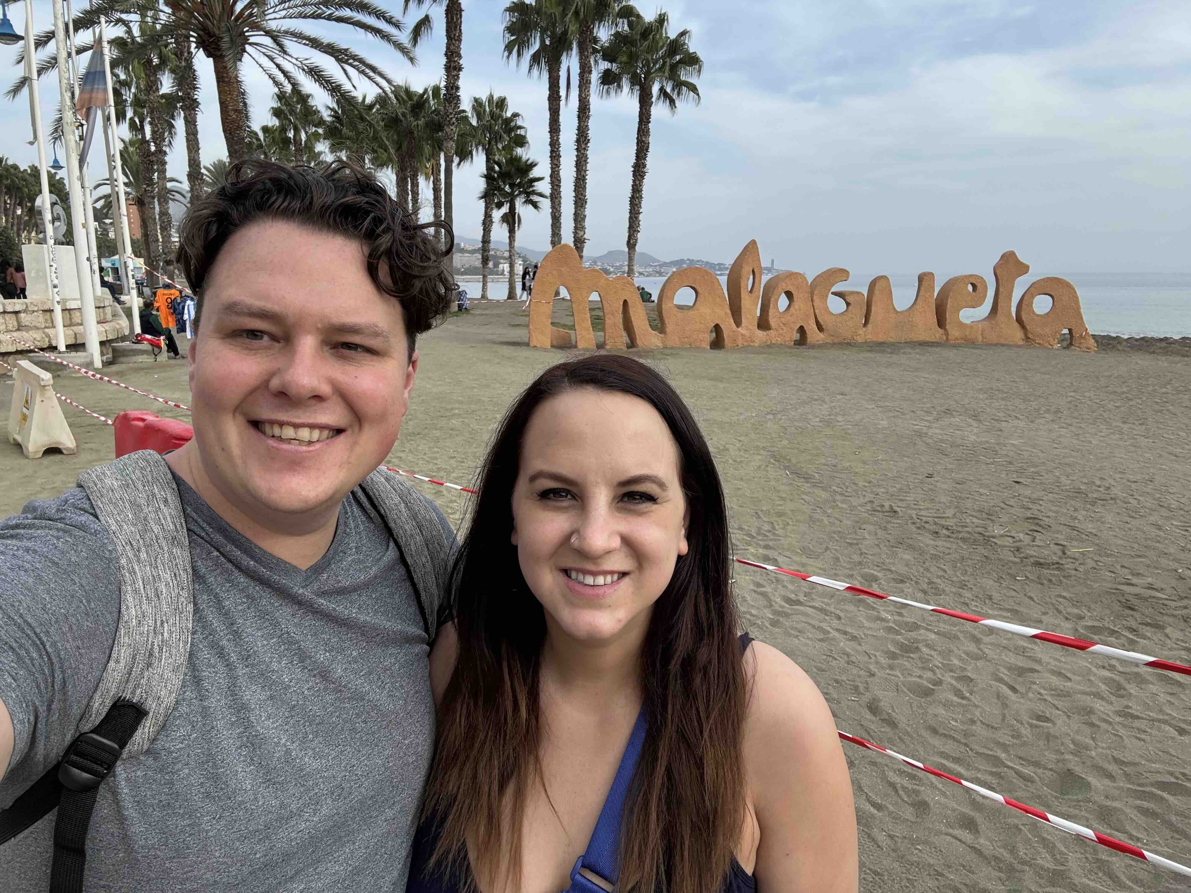 posing with the beach sign